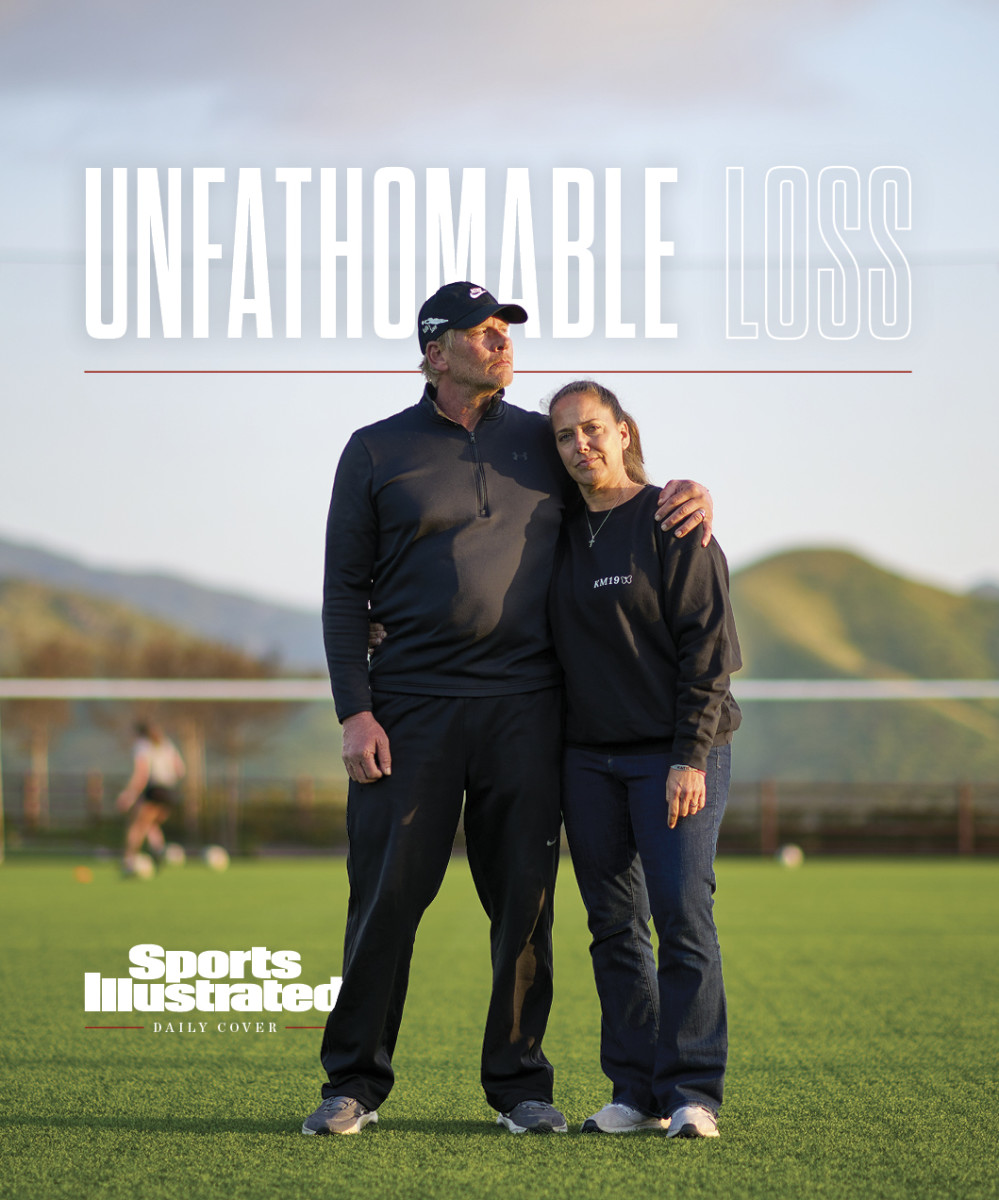 Steve and Gina Meyer stand together on a soccer field.
